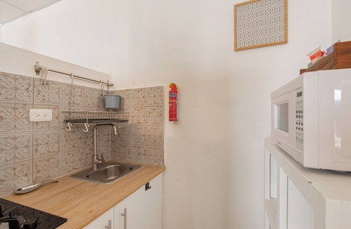Zona Colonial Apartment | Anacaona Studio with ensuite bath, fully equipped kitchenette, and garden views.