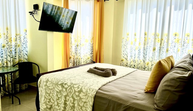 Romantic Hispanic 304 private room with refrigerator and dining area.